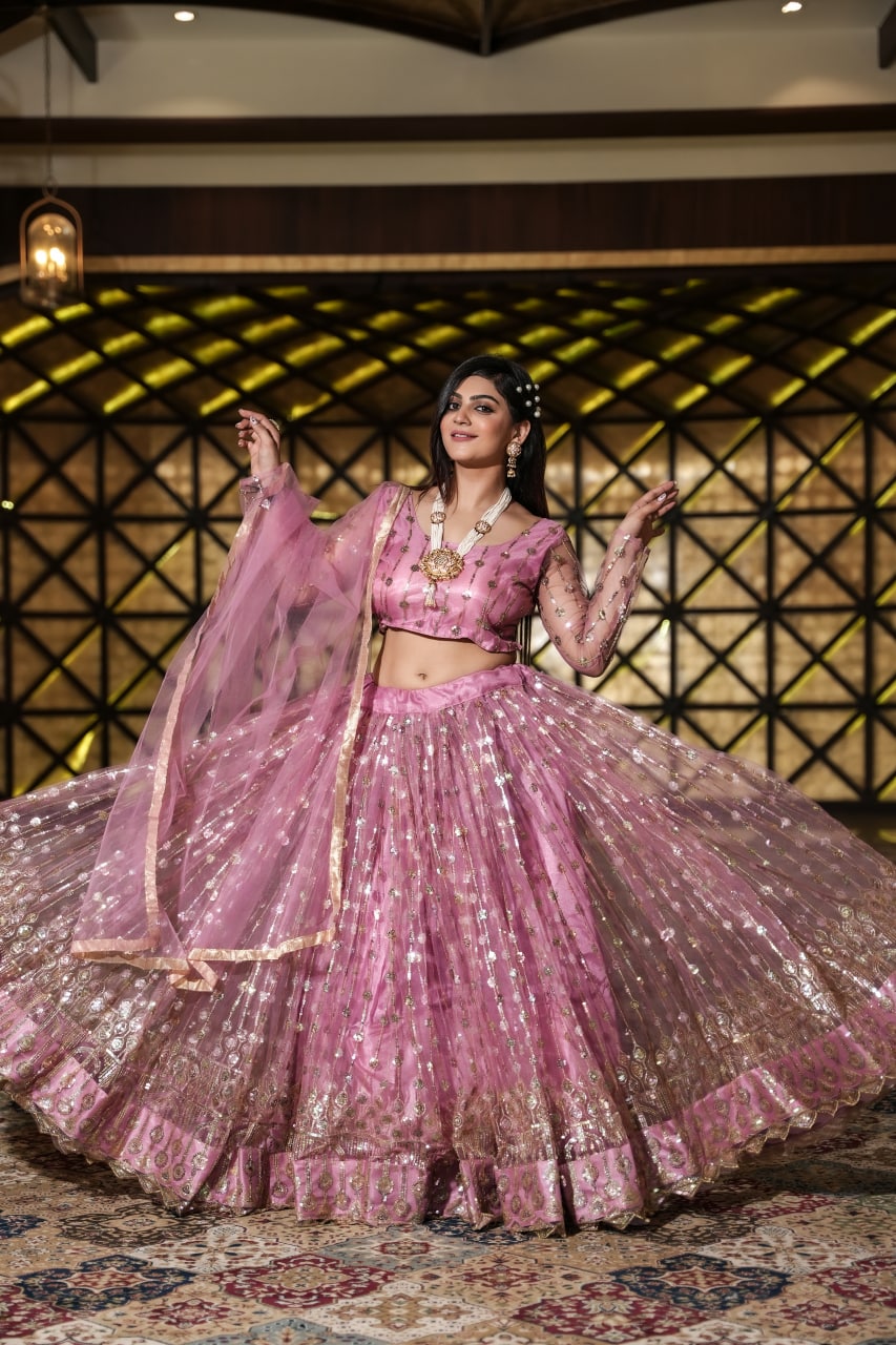 Shining Peach Color Embroidery Work Net Lehenga Choli